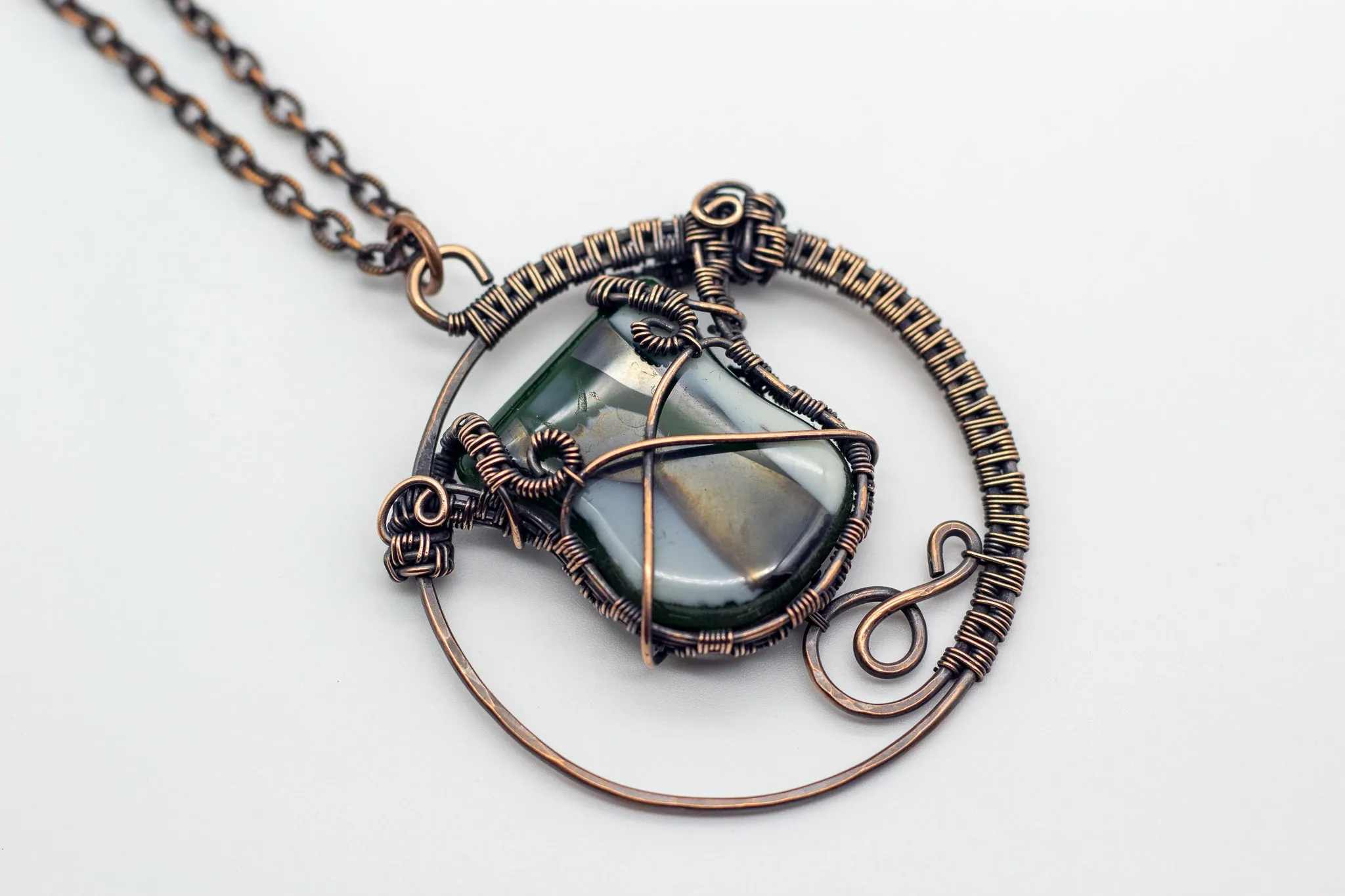 Circular Copper Wire Wrapped Pendant with Streaked Green and White Fused Glass