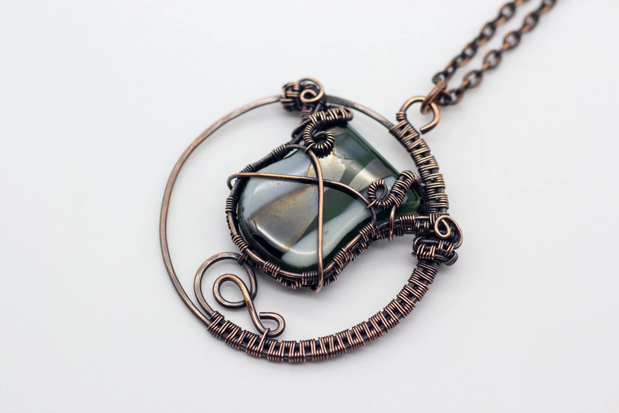 Circular Copper Wire Wrapped Pendant with Streaked Green and White Fused Glass