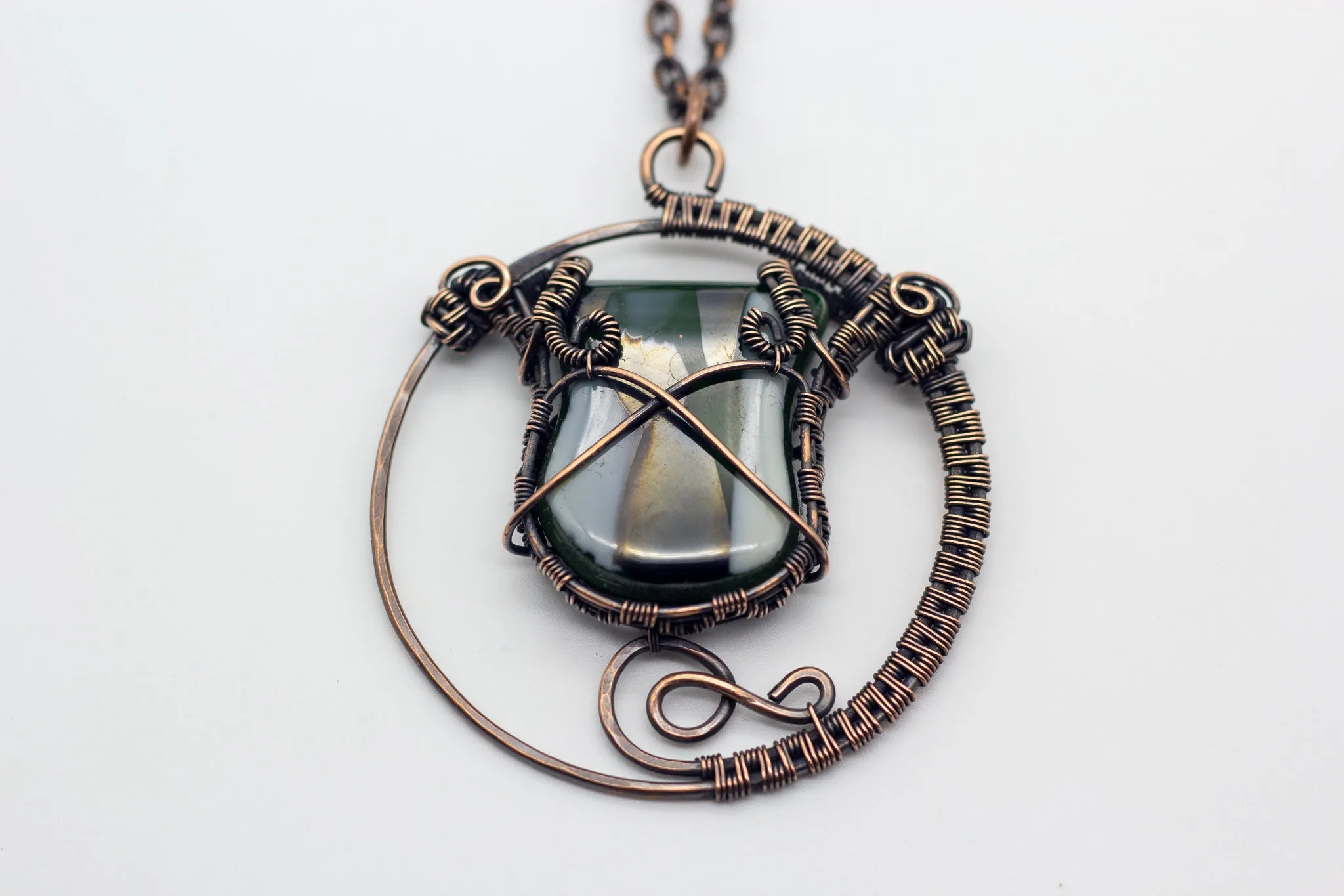 Circular Copper Wire Wrapped Pendant with Streaked Green and White Fused Glass