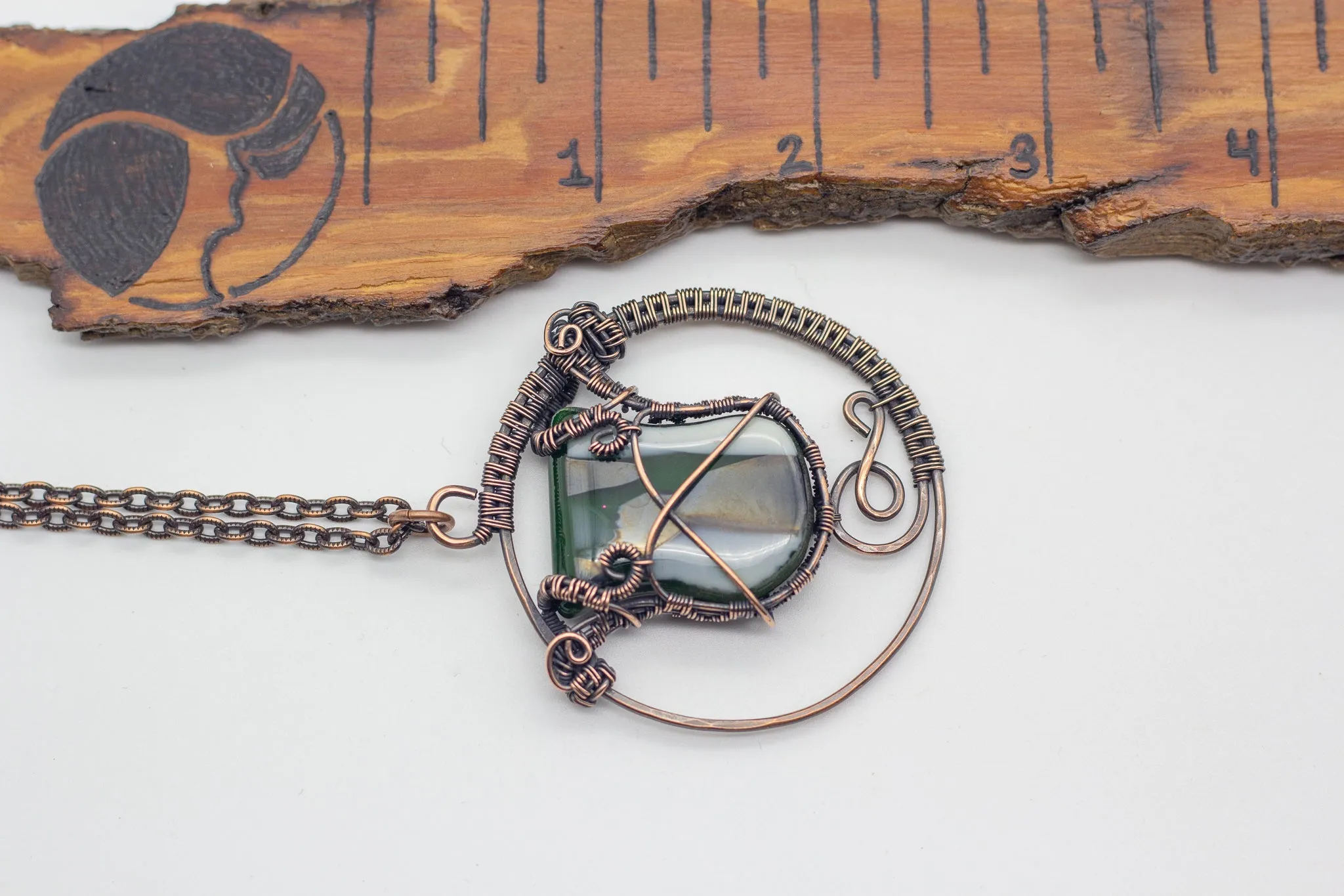 Circular Copper Wire Wrapped Pendant with Streaked Green and White Fused Glass