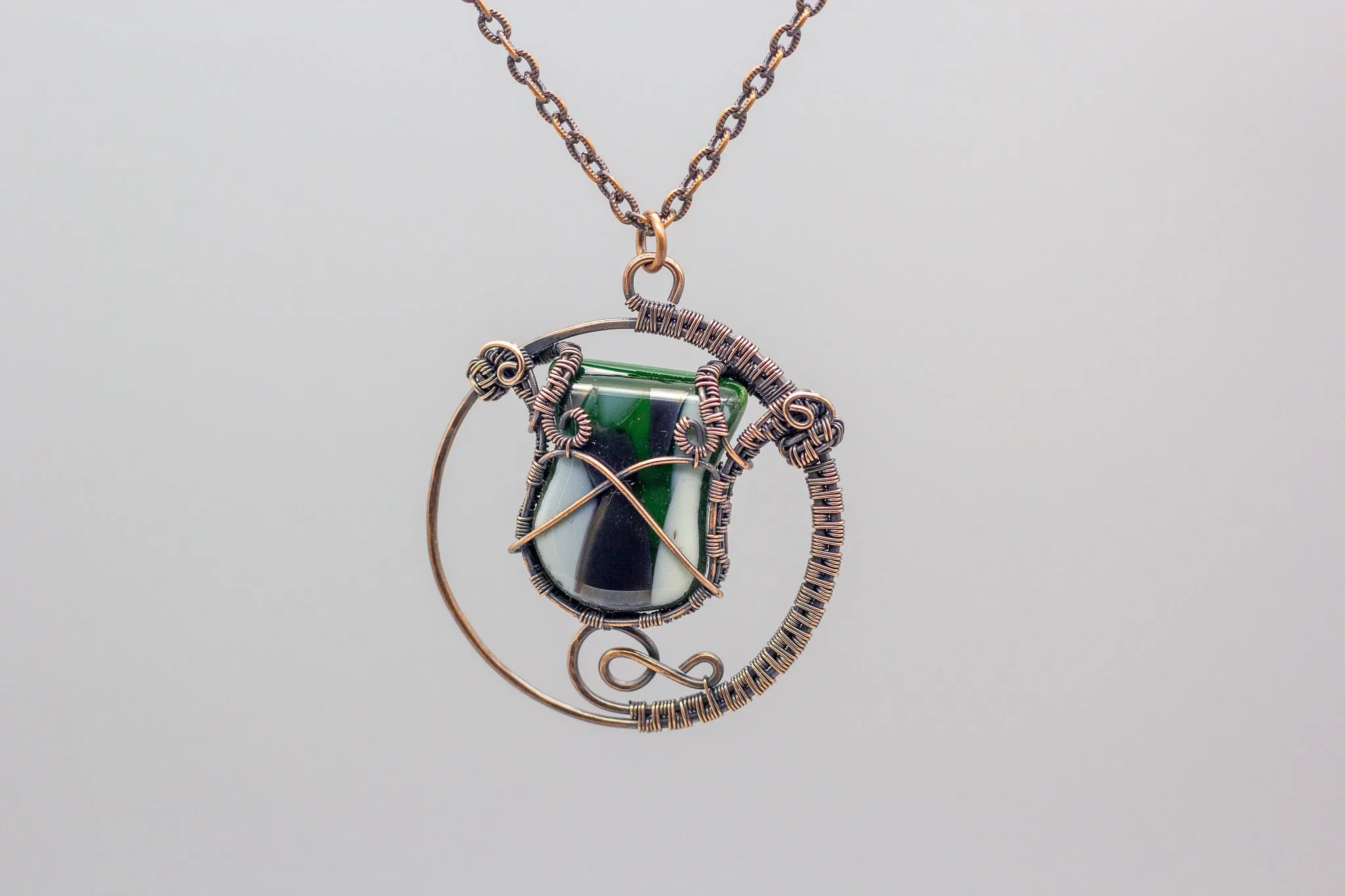 Circular Copper Wire Wrapped Pendant with Streaked Green and White Fused Glass