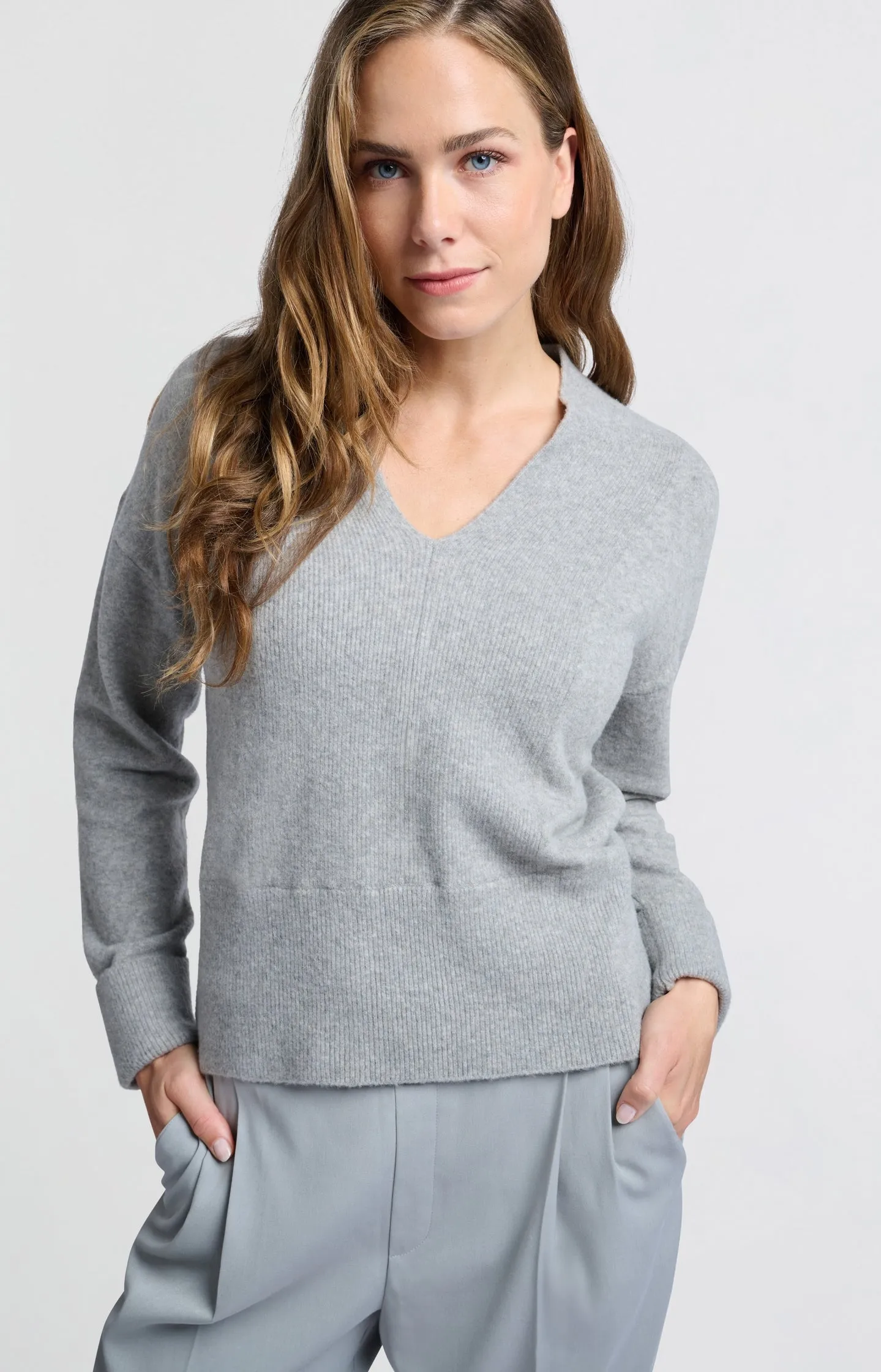 Soft sweater with deep V-neck and subtle rib details